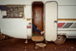 Al Jazeera feature on the Ponte Building and surrounding areas in Johannesburg CBD, South Africa. A local shop owner sits with his foot holding the door open of a caravan. He sells his goods from there. . Picture: Cornel van Heerden/Al Jazeera